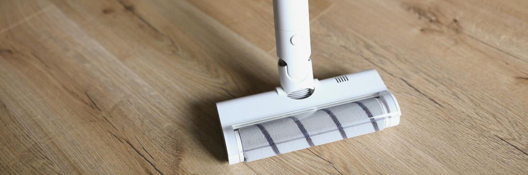 Low angle of woman wiping wooden laminate with mop, domestic work, housewife doing cleaning at home. Cleaning routine, housekeeping, household chores, cleaning service concept