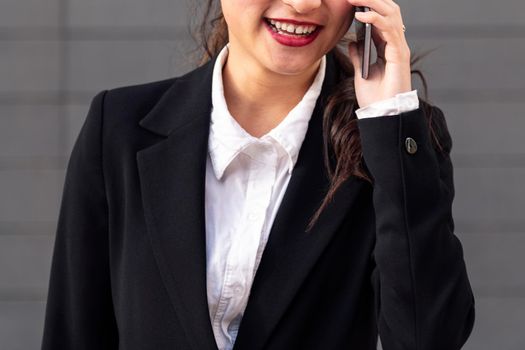 smiling unrecognizable businesswoman talking by phone, concept of entrepreneurship and business, copy space for text