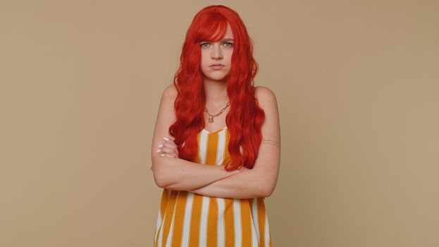 Dissatisfied woman shaking head no, asking reason of failure, expressing disbelief irritation, feeling bored, disappointed in result, bad news. Ginger girl isolated alone on beige studio background