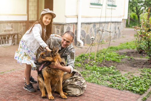 military father meeting with daughter and dogs.