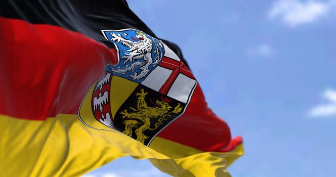The flag of Saarland waving in the wind on a clear day. Saarland is a German state (Land) situated in southwestern Germany