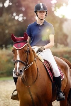 Portrait of Happy young rider after winning a show jumping competition.