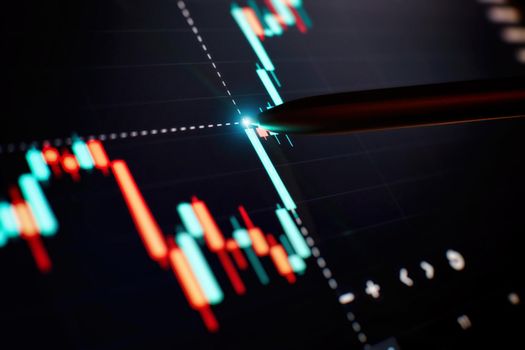 Financial chart with pen, stock analysis data for business background on digital screen. Graphs of the growth of the financial market forex. trading candlestick chart