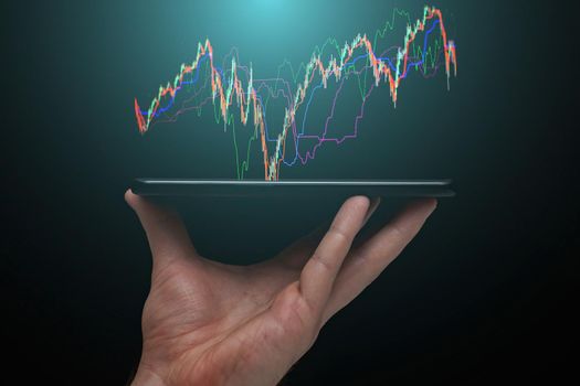 Stock market, Business growth, progress or success concept. Hand of Businessman or trader is showing a growing virtual hologram stock on smartphone