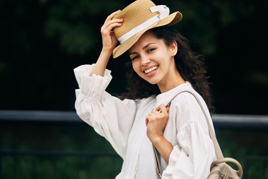 Young beautiful girl in a hat in a summer park. High quality photo