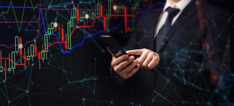 Man using smartphone with graphs analysis candle line and foreign currency rate on bokeh colors light. Manager analyzing investment statistics and indicators on dashboard for trading products.