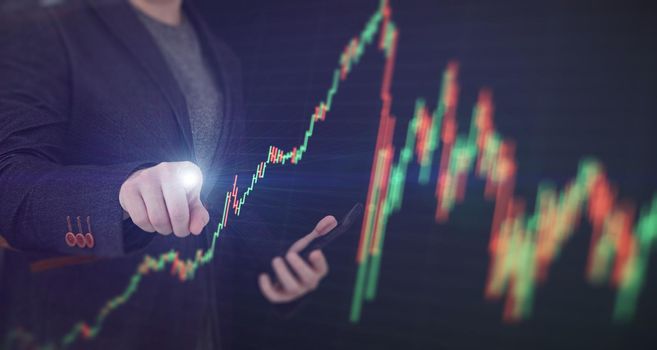 Stock market, Business growth, progress or success concept. Hand of Businessman or trader is showing a growing virtual hologram stock on smartphone