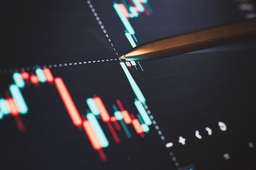 Financial chart with pen, stock analysis data for business background on digital screen. Graphs of the growth of the financial market forex. trading candlestick chart