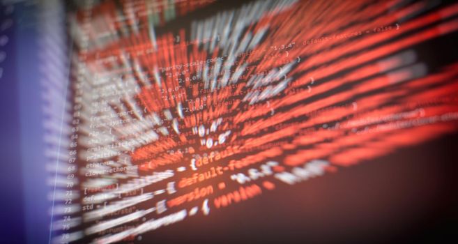 Security code on a computer display, close up. Database bits access stream visualisation. Php language and coding function developer