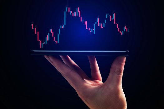 Stock market, Business growth, progress or success concept. Hand of Businessman or trader is showing a growing virtual hologram stock on smartphone