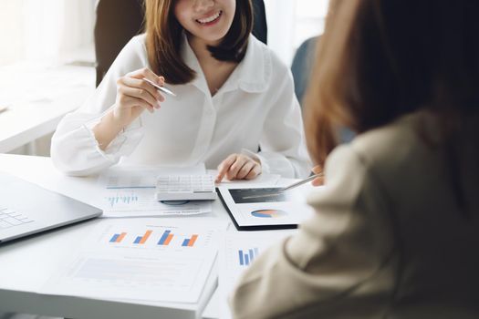 Negotiation, Analysis, Discussion, Asian woman economist and marketer pointing to a financial data sheet to plan investments to prevent risks and losses for the company.