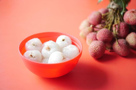 Lychee fruits in a red color bowl ,