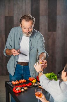 aged man cooking in the kitchen