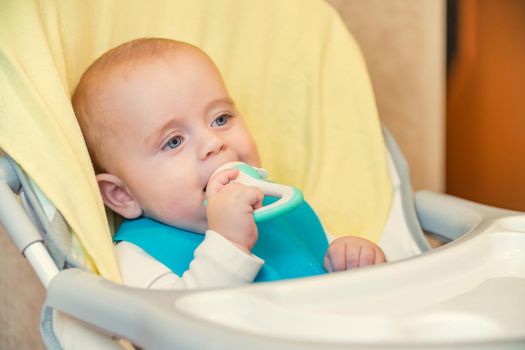 little boy eating sitting at the table