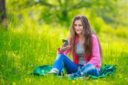 girl with a phone in her hands in nature