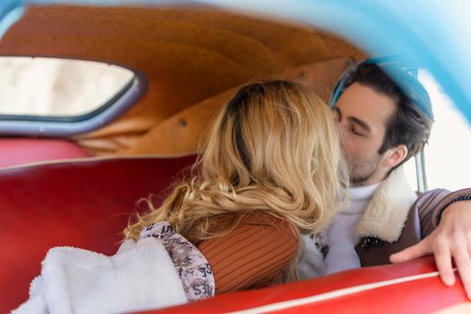 beautiful couple sitting in the back seat of a car