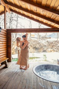 young couple hugging near a vat of water