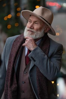 portrait of a bearded man aged on the street in the city