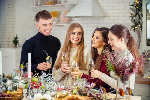 guy with girls drinking champagne standing at the table
