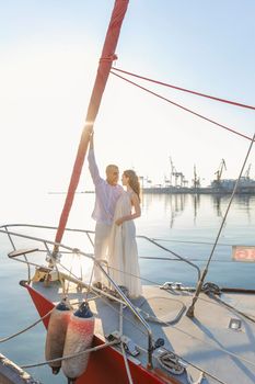 couple standing on the front of the yacht