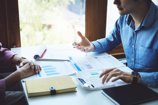 Teamwork concept, consultation, economist pointing budget, finance and investment documents, discussing and planning finances with advisors in conference room.