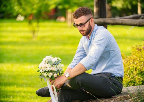 guy with a wedding bouquet in his hands
