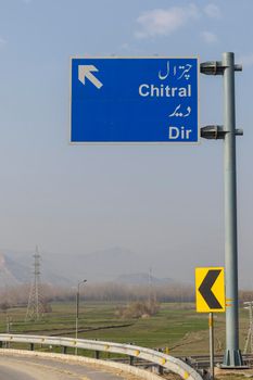 Dir, KPK, Pakistan - March, 7, 2022: Pakistan highway with signs to district Chirtal and district Dir