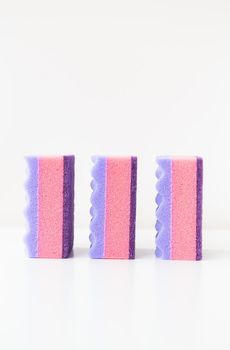 A group of multi-colored kitchen sponges. Set of colorful sponges for the kitchen. Cleaning and cleaning concept