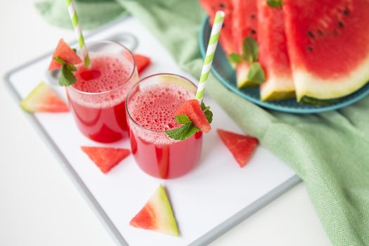 A glass of freshly squeezed fresh watermelon juice, a healthy watermelon and mint leaf smoothie