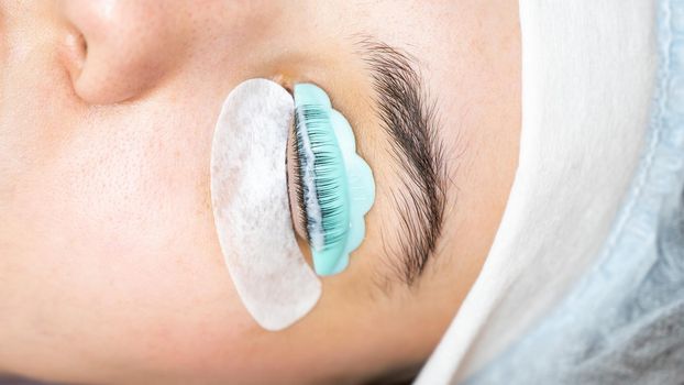 Close-up portrait of a woman on eyelash lamination procedure