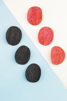 Red and black potato chips with salt, chili pepper. Isometric drawing. Chips background on white and blue background