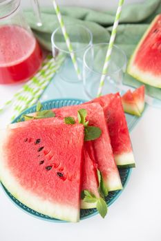 The process of making freshly squeezed juice from fresh watermelon, a healthy smoothie made from watermelon and mint leaves. A refreshing summer cocktail