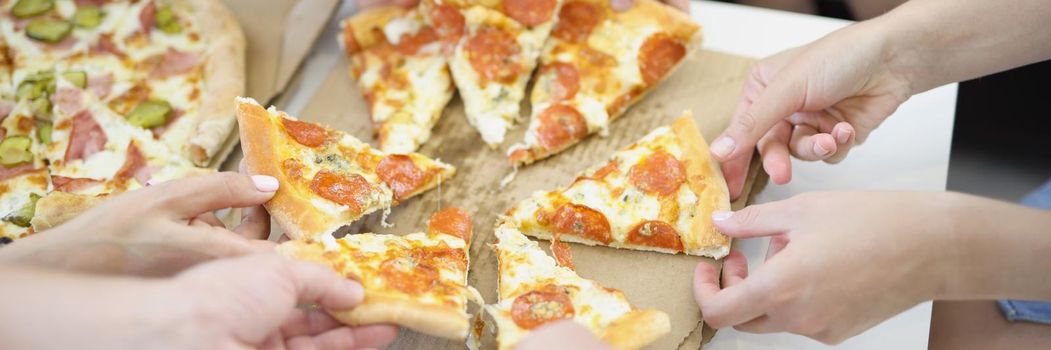 Close-up of people hands of big company take piece. Hot smelly pizza with tomatoes and cheese, order pizza as snack. Fast food, takeaway, food, hungry, party, lunch, holiday concept