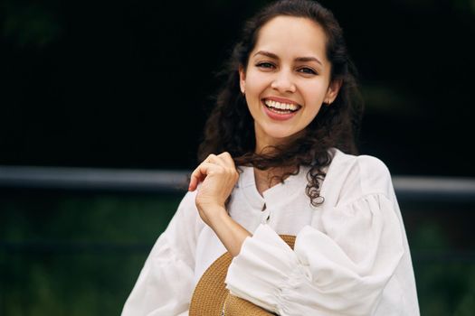 Young beautiful cheerful girl in a summer park. High quality photo