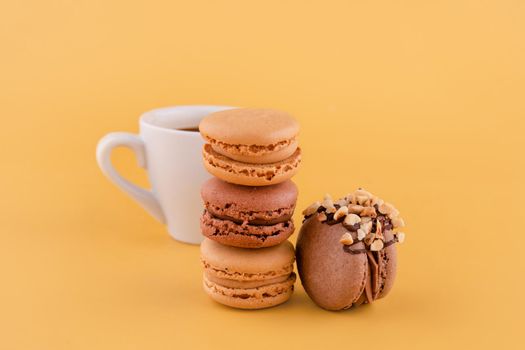 Close up of Americano and macarons on yellow background