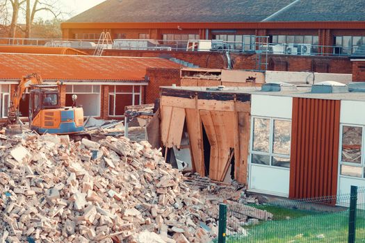 Ruins of a demolished building. Dismantling an old building. Pile of rubble at demolishing site