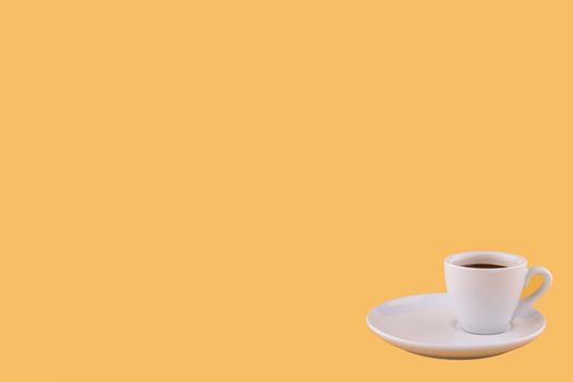 cup of espresso coffee on a yellow background. Space for text.