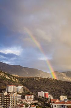 Rainbow over a green summer hills and mountains.