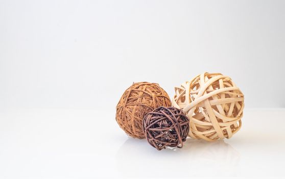 wicker balls from a vine of different natural colors on a light background