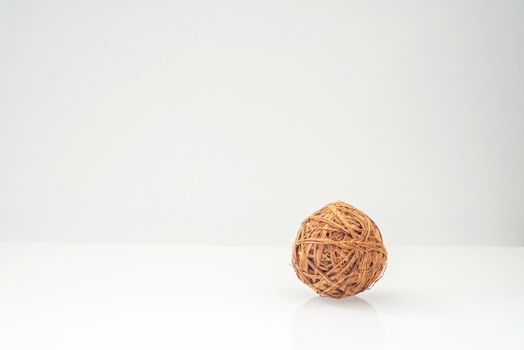 wicker ball from a vine natural colors on a light background