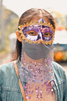 Nicaraguan girl with a mask participating in a cultural carnival in the city of Masaya