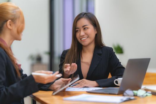 Cheerful business people discussing or brainstorming about marketing plan and financial of company. Account concept