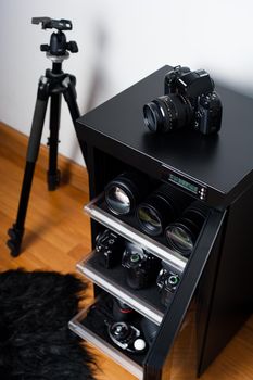 electronic dehumidify dry cabinet for storage cameras lens and other photography equipment. Shallow depth of field, closeup at camera on the cabinet.