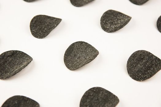 Drawing of black chips on a white background. The concept of repetition. View from above