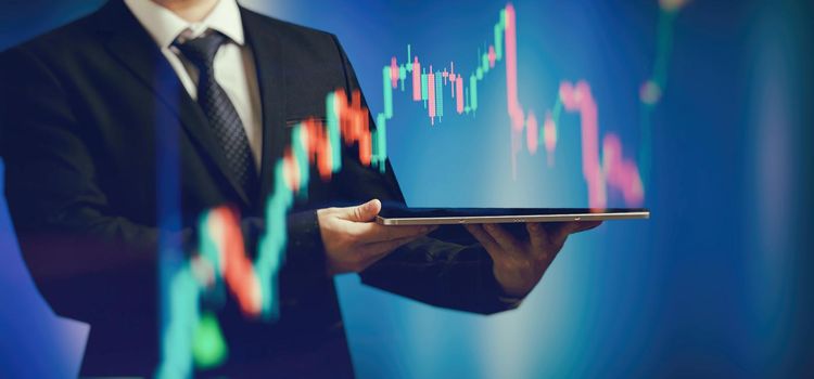 Businessman holding stock tablet ,virtual technical investment graph chart for analysis stock market , Banking financial and planing concept.