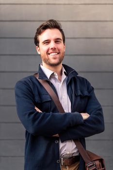 portrait of a smiling caucasian man entrepreneur with his arms folded, concept of entrepreneurship and business
