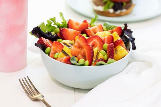 Fresh fruit salad with strawberries, edame and grilled pinapple.