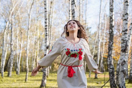 Indigenous people. beautiful woman in national ukrainian national traditional costume clothes dancing in forest