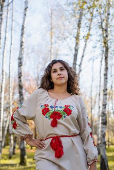 Indigenous people. beautiful woman in national ukrainian national traditional costume clothes walking in forest