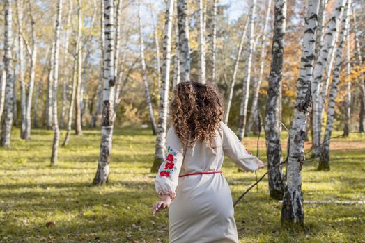 Indigenous people. beautiful woman in national ukrainian national traditional costume clothes dancing in forest